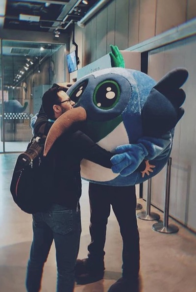Sergei Liebich hugging a mascot at a tech event